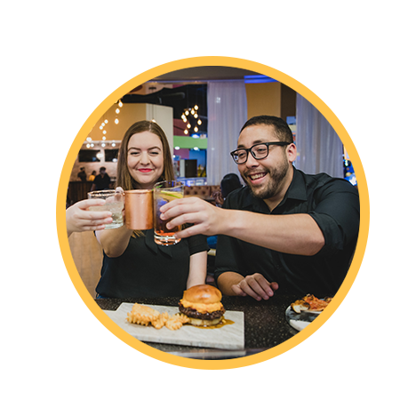 Friends eating pizza and burgers in the restaurant at District 850.